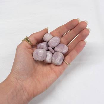 A handful of lilac lepidolite tumbles