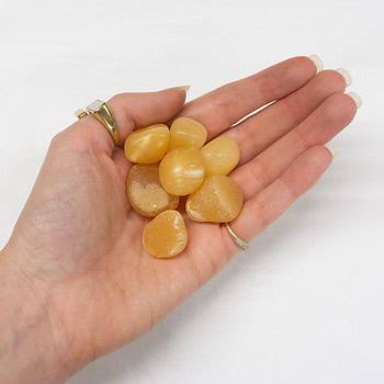 A handful of Orange Calcite